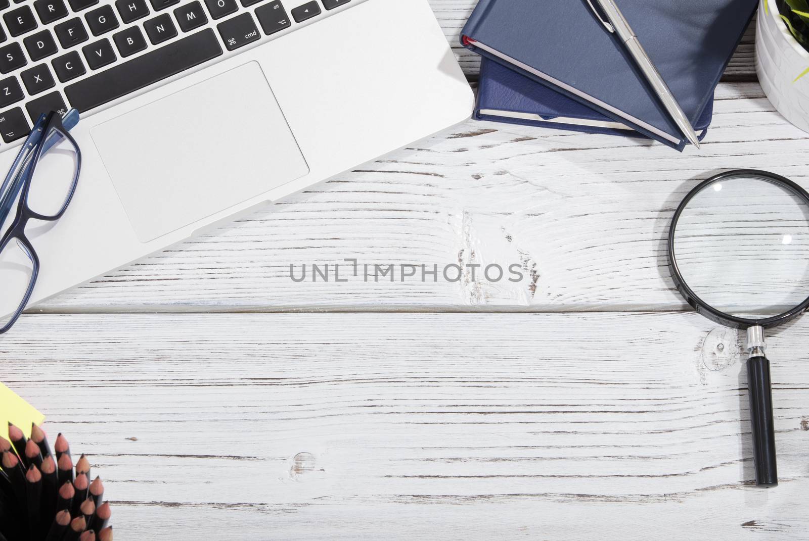 mix of office supplies and gadgets on a wooden table background. view from above