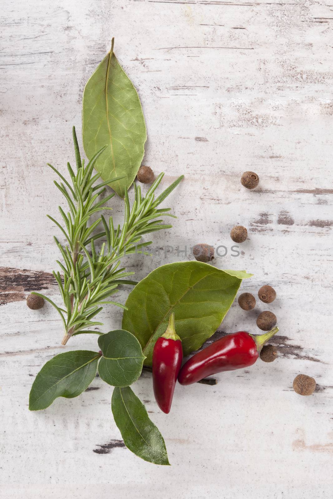 Bay leaves, spice and condiments wooden background. by eskymaks