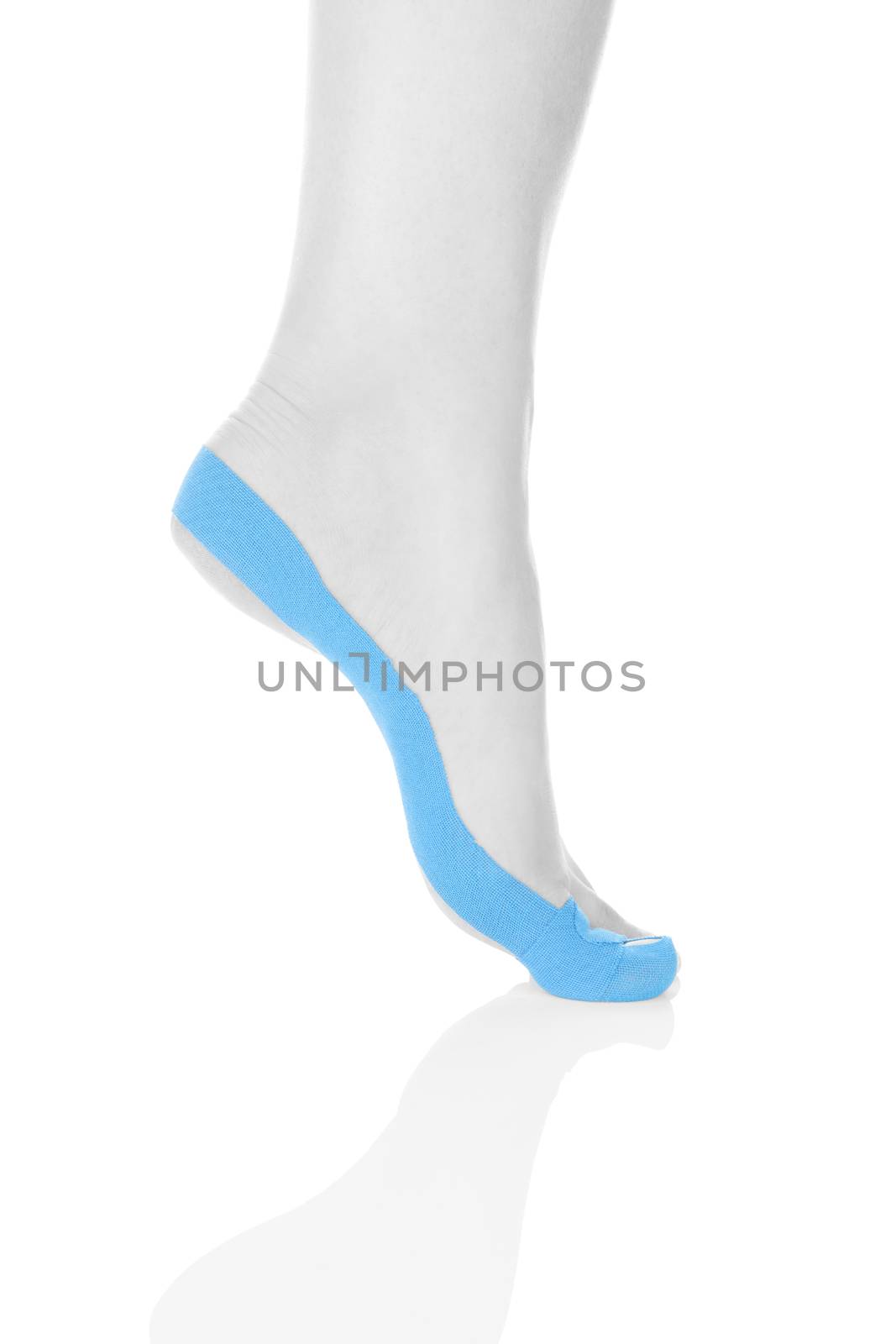 Therapeutic tape on female foot isolated on white background. Chronic pain, alternative medicine. Rehabilitation and physiotherapy.