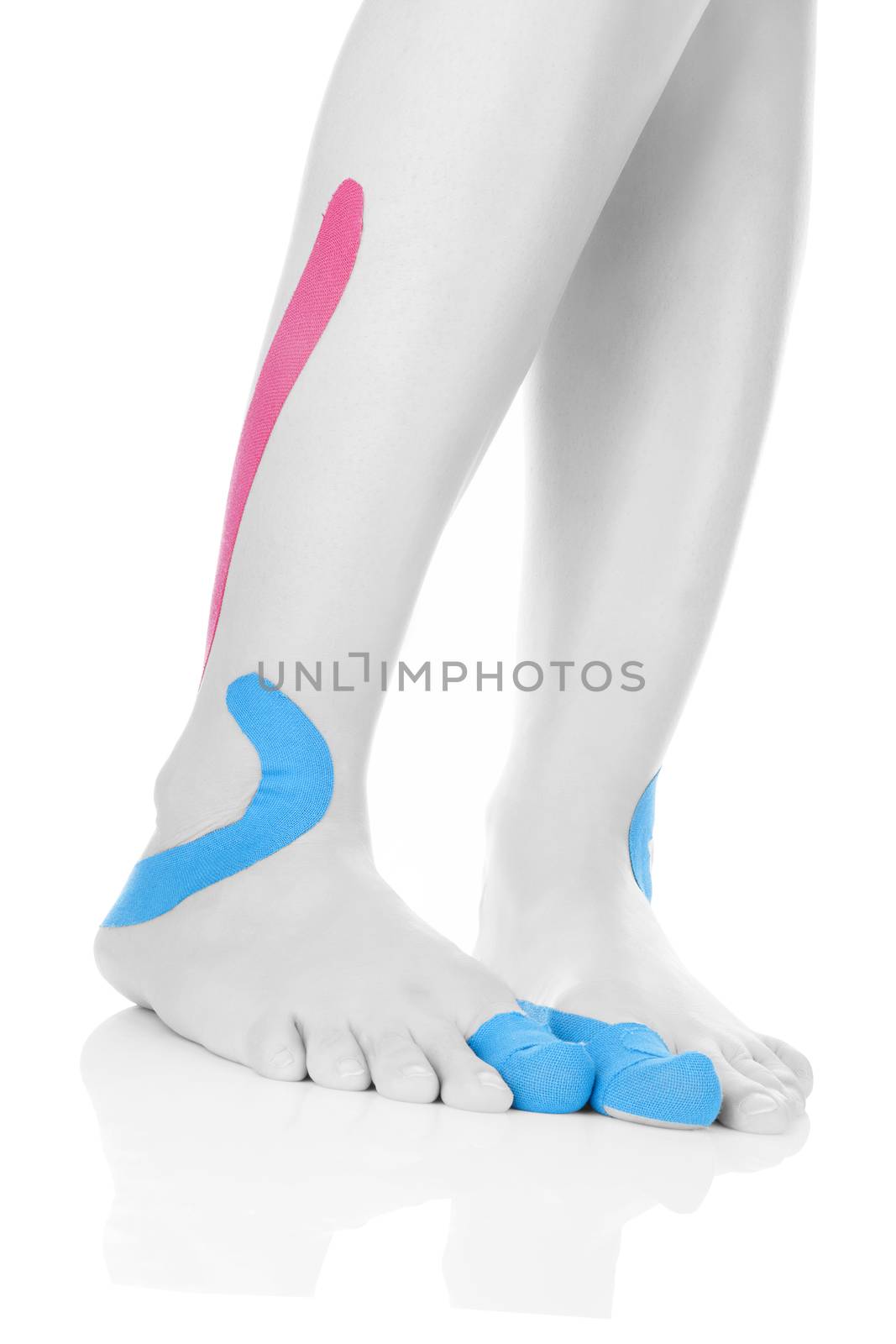 Therapeutic tape on female feet isolated on white background. Chronic pain, alternative medicine. Rehabilitation and physiotherapy.