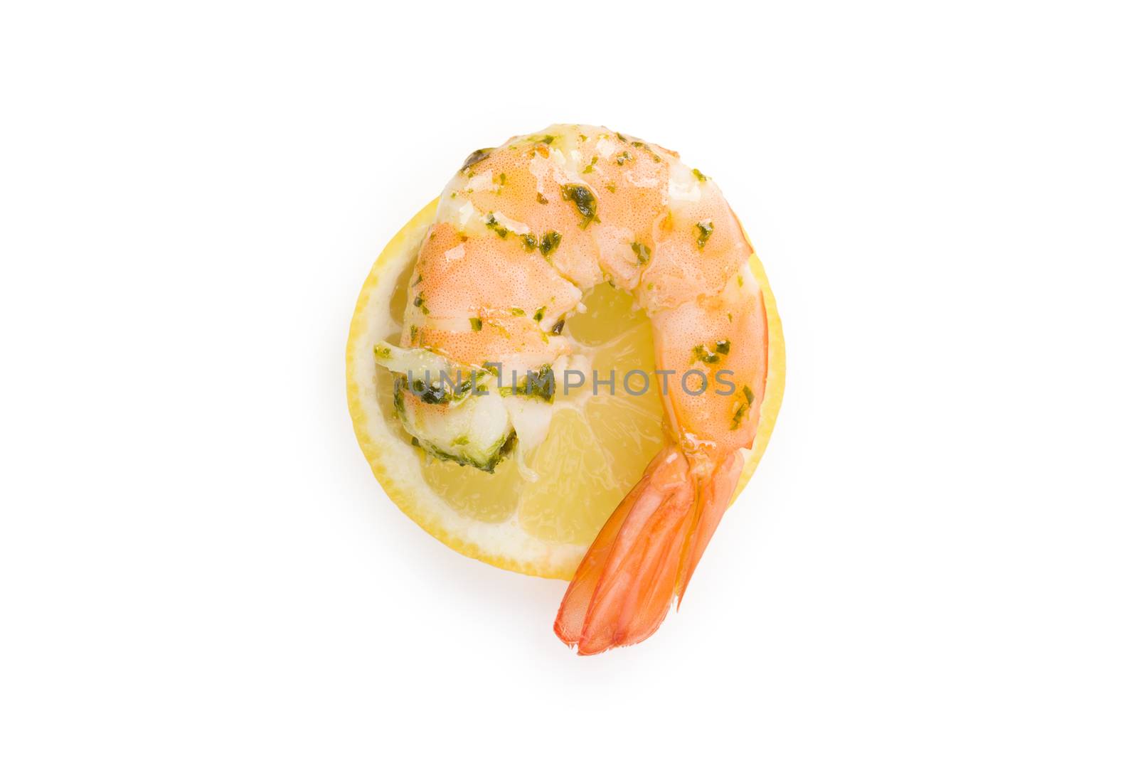 Cooked shrimp on lemon slice on white background top view. Culinary seafood eating. 