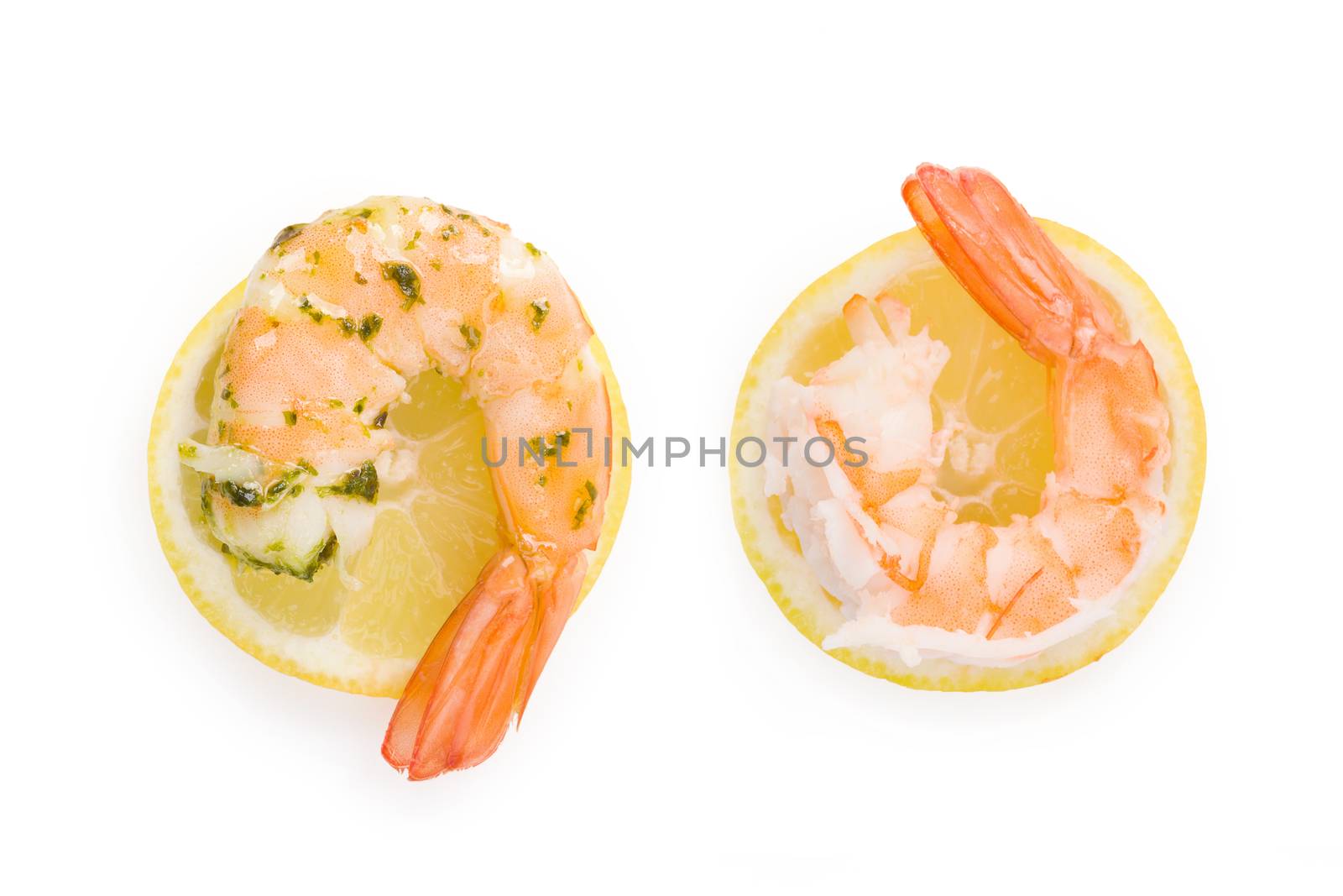 Cooked shrimp on lemon slice on white background top view. Culinary seafood eating. 