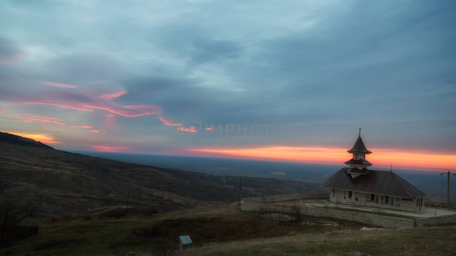 One stone church in a beautiful morning sunrise at Buzau, Romania.