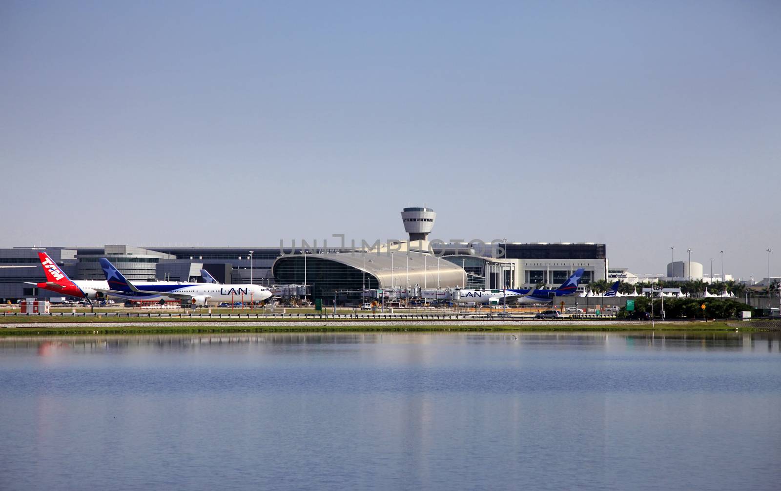 Miami, Florida, USA - May 9, 2013: Panoramic photo of the famous Miami International Airport with lots of airplanes loading and unloading passenger and cargo on May 9, 2013 in Miami, Florida, USA.