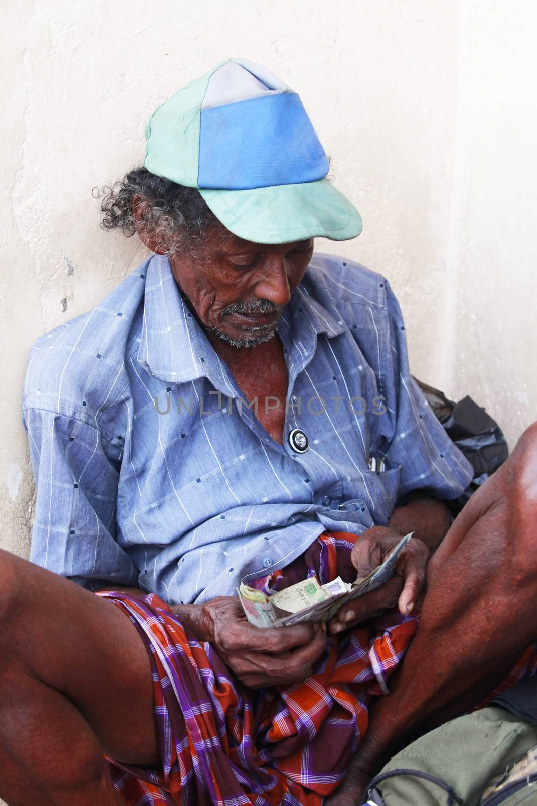 Colombo, Sri Lanka - April 9, 2011: Drunk old the beggar in the street on Sri Lanka