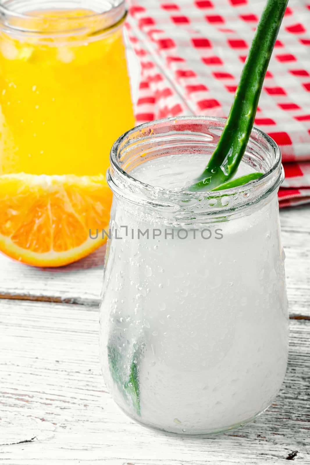Freshly squeezed orange juice and citrus fruit in stylish glass jars