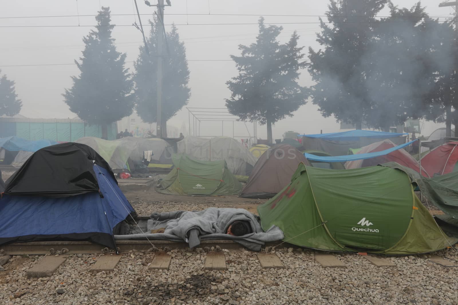 GREECE, Idomeni: A picture is taken of a makeshift camp set by migrants on April 4, 2016 at Greece-Macedonian border, near Idomeni village where thousands of people are stranded by the Balkan border blockade. Migrants return from Greece to Turkey begun under the terms of an EU deal that has worried aid groups that same day, as Athens struggles to manage the overload of desperate people on its soil. Over 51,000 refugees and migrants seeking to reach northern Europe are stuck in Greece, after Balkan states sealed their borders. Under the agreement, designed to halt the main influx which comes from Turkey, all irregular migrants arriving since March 20 face being sent back, although the deal calls for each case to be examined individually. For every Syrian refugee returned, another Syrian refugee will be resettled from Turkey to the EU, with numbers capped at 72,000.