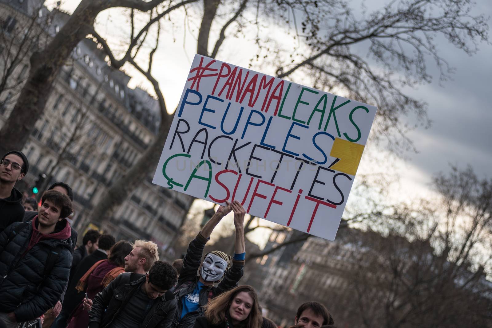 FRANCE, Paris: A man holds a placard reading #PanamaLeaks, People, Enough of extorsions referring to the massive data leak called Panama Papers as hundreds of militants of the Nuit Debout or Standing night movement hold a general assembly to vote about the developments of the movement at the Place de la Republique in Paris on April 4, 2016. It has been five days that hundred of people have occupied the square to show, at first, their opposition to the labour reforms in the wake of the nationwide demonstration which took place on March 31, 2016. 