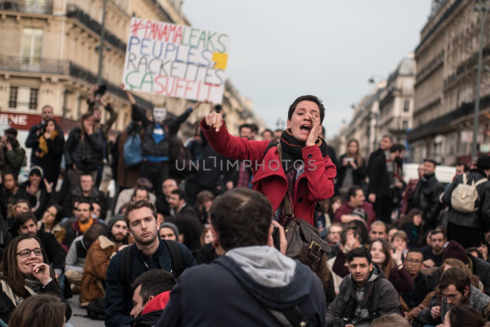 FRANCE, Paris: A woman addresses to a crowd of people as hundreds of militants of the Nuit Debout or Standing night movement hold a general assembly to vote about the developments of the movement at the Place de la Republique in Paris on April 4, 2016. It has been five days that hundred of people have occupied the square to show, at first, their opposition to the labour reforms in the wake of the nationwide demonstration which took place on March 31, 2016. 