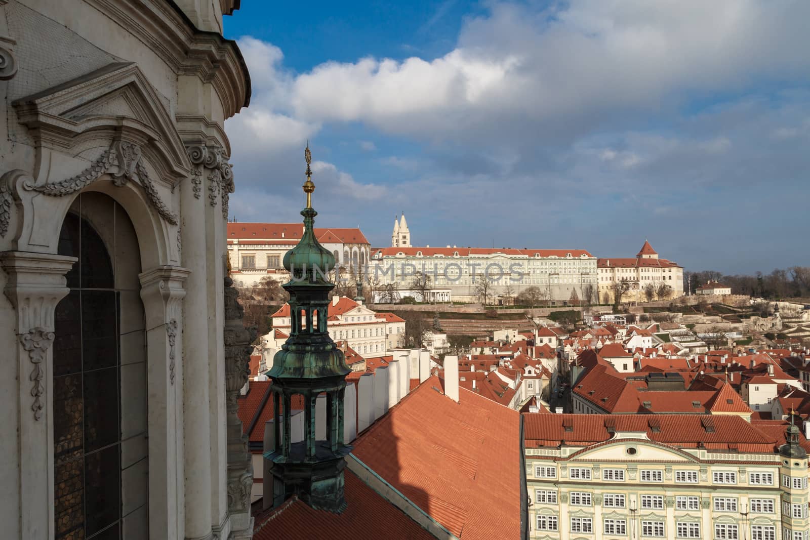 General top view of Prague cityscape view with historical gothic buildings around, on cloudy sky background.