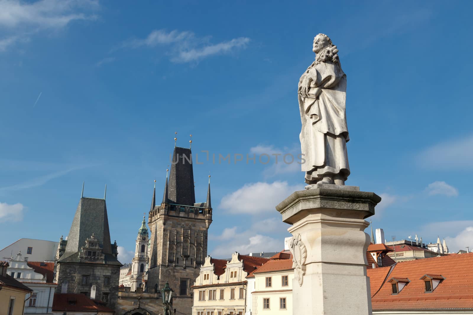 Close up detailed view of historical gothic granit sculptures on Charles Bridge in Prague, on bright blue sky background.