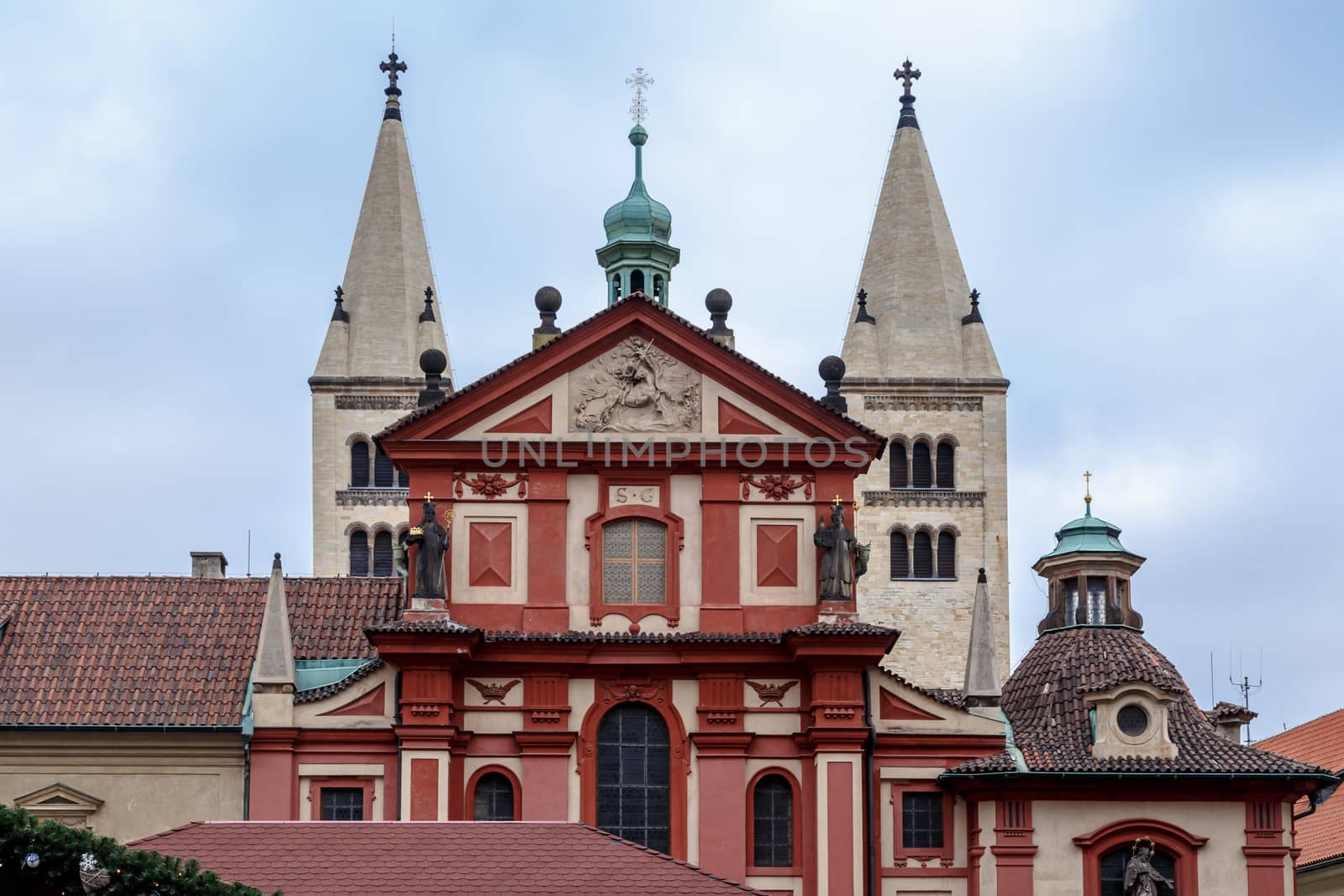 Front view of St George Basilica, the oldest living church built within Prag Castle, on cloudy sky background.