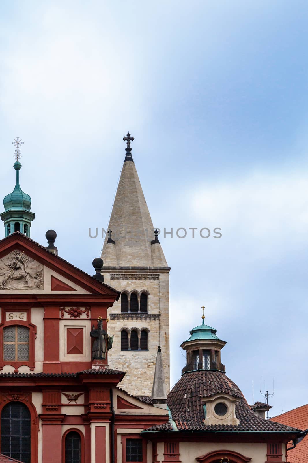 Front view of St George Basilica, the oldest living church built within Prag Castle, on cloudy sky background.