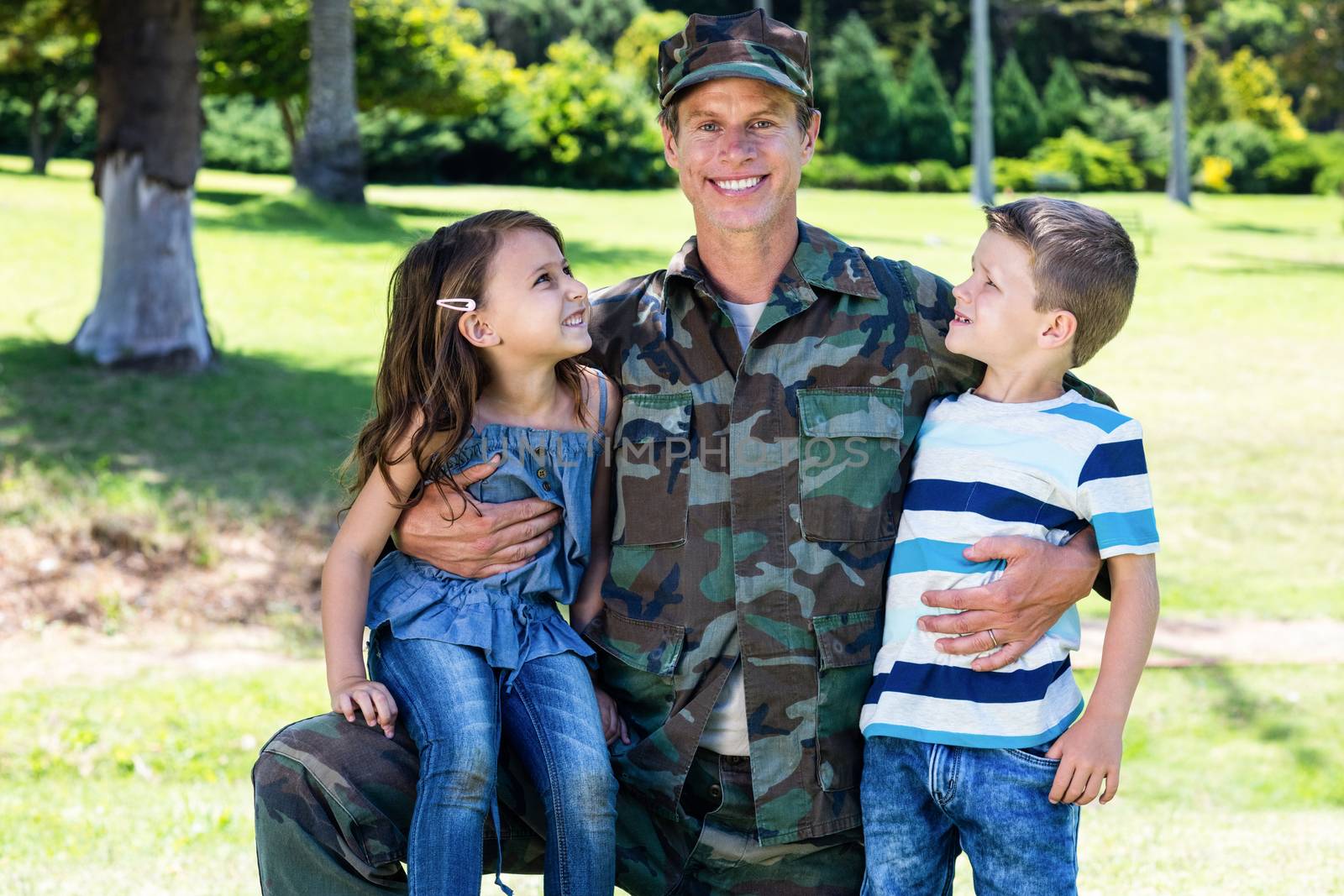 Happy soldier reunited with his son and daughter by Wavebreakmedia