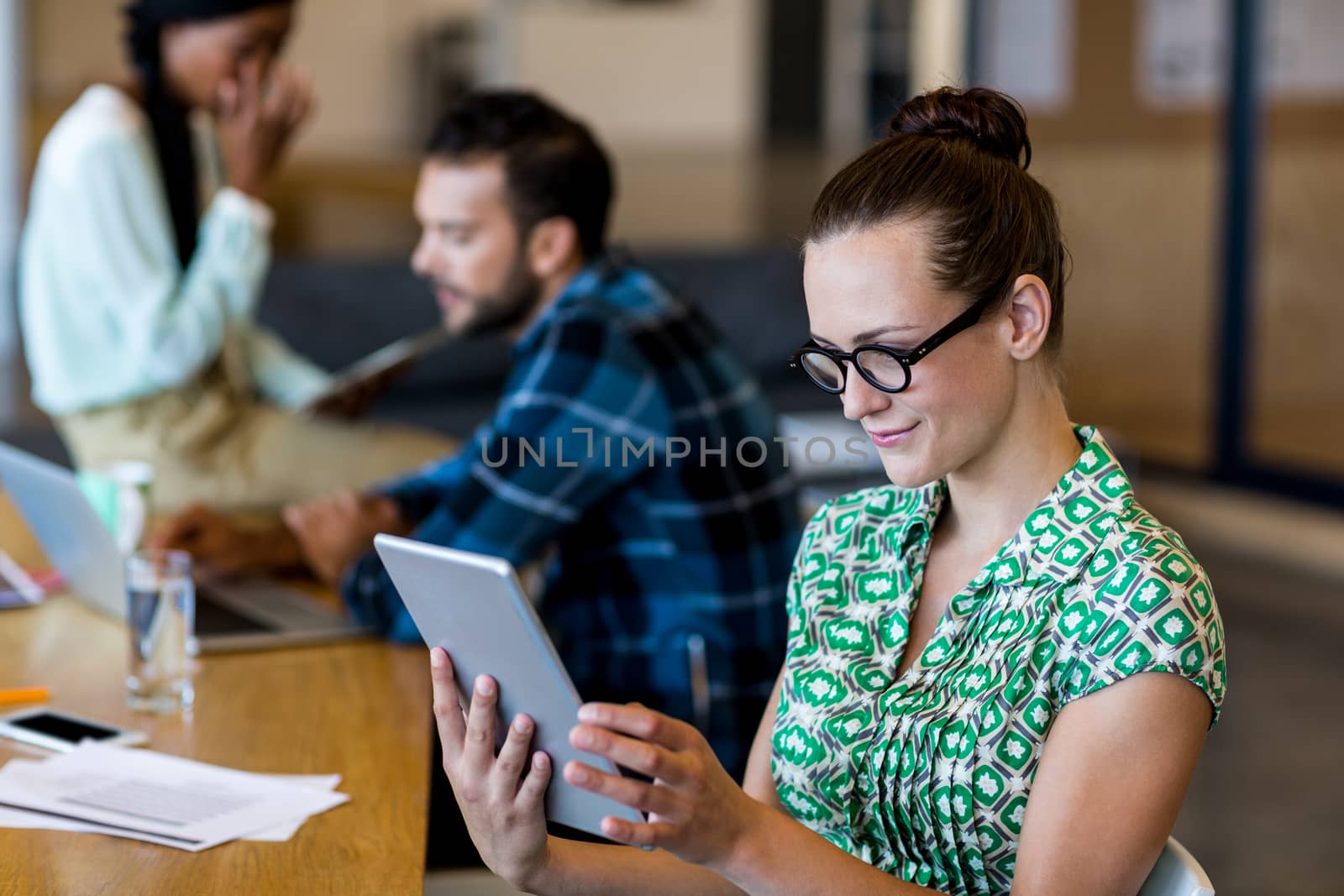 Young woman using digital tablet in the office