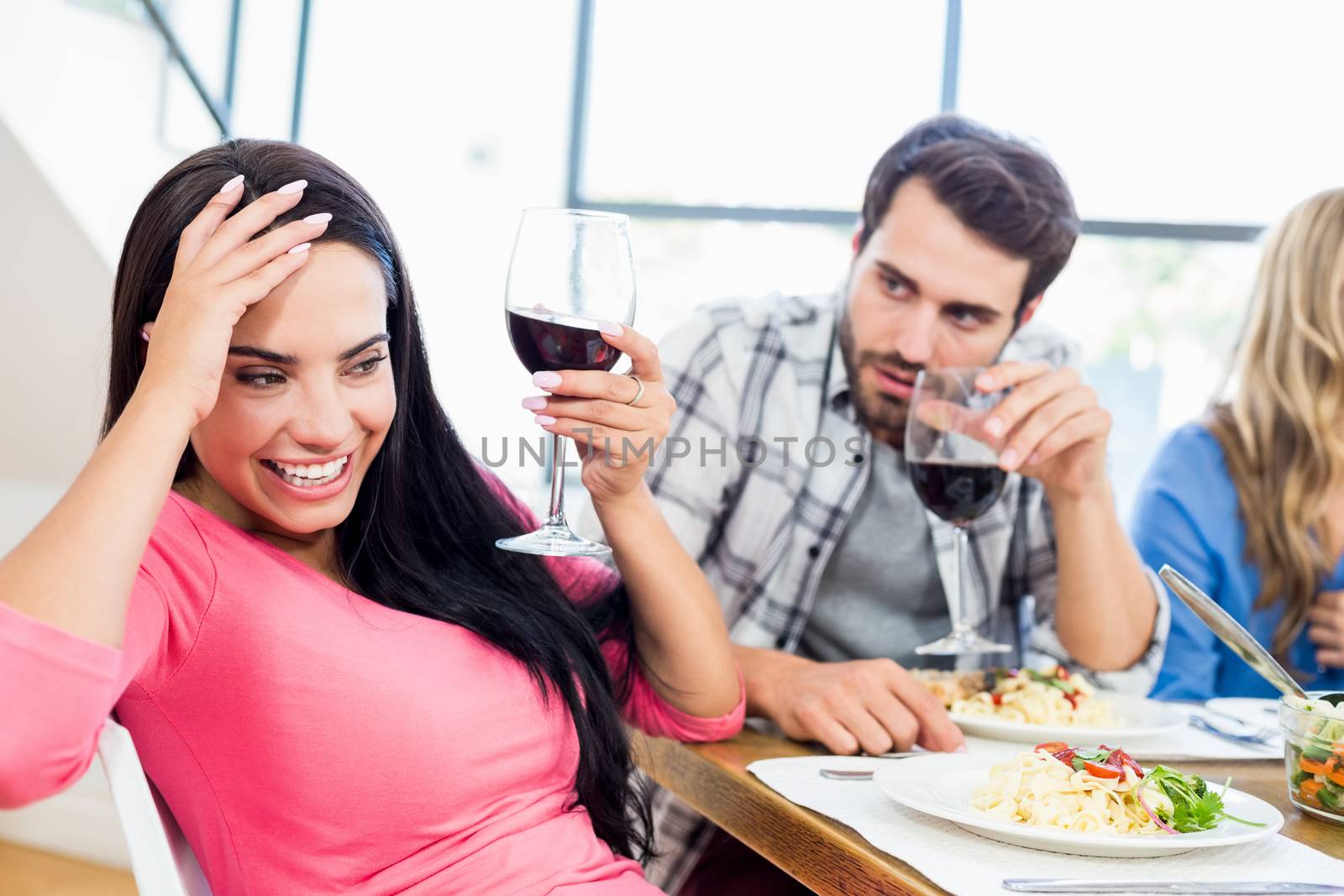 Man looking drunk woman with wine glass at home