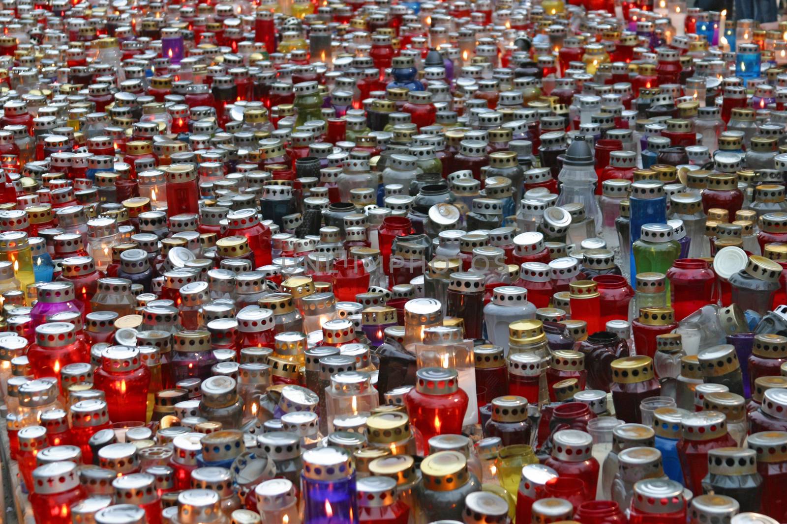 Memorial candles shining at the cemetery on the All Saints Day