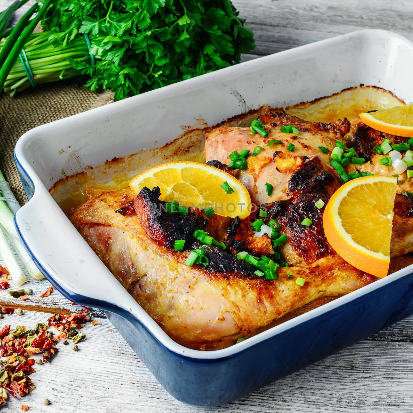 Chicken feet cooked with juicy oranges in the baking dish