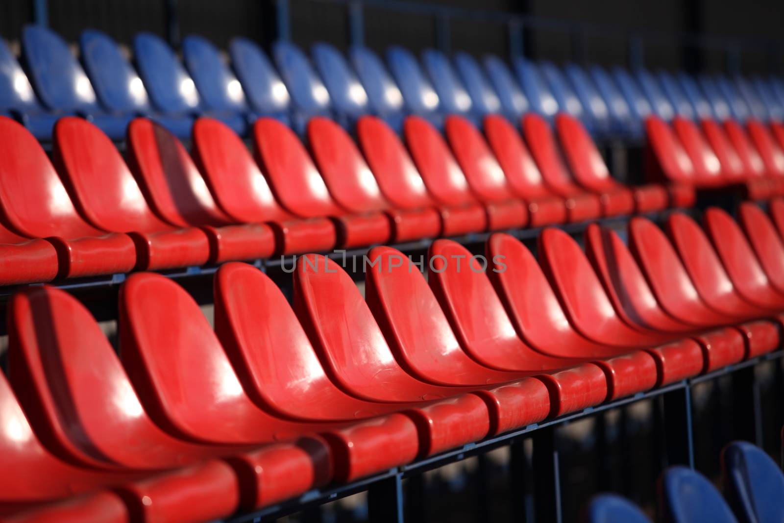 Red chairs bleachers in stadium close to
