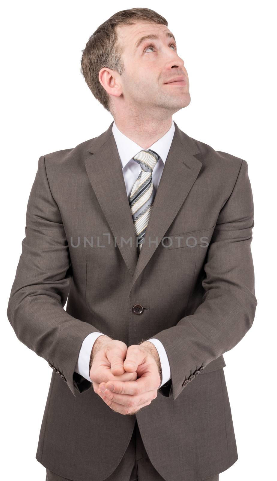 Smiling businessman holding hands in front of him and looks up to side