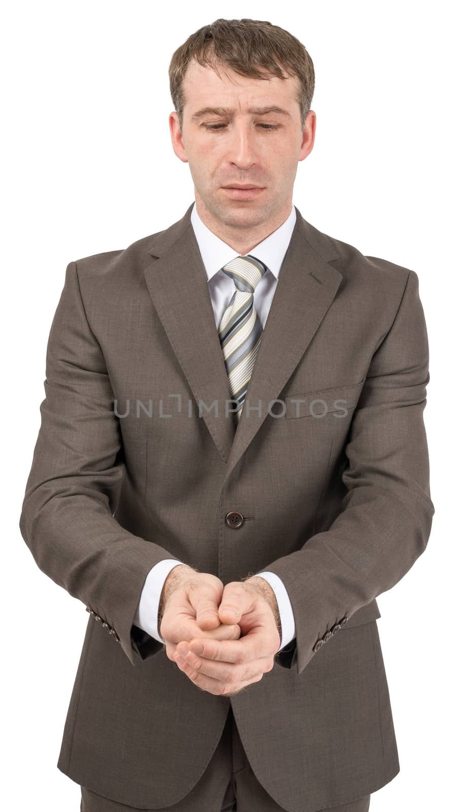 Unhappy businessman looking at his hands in front of him