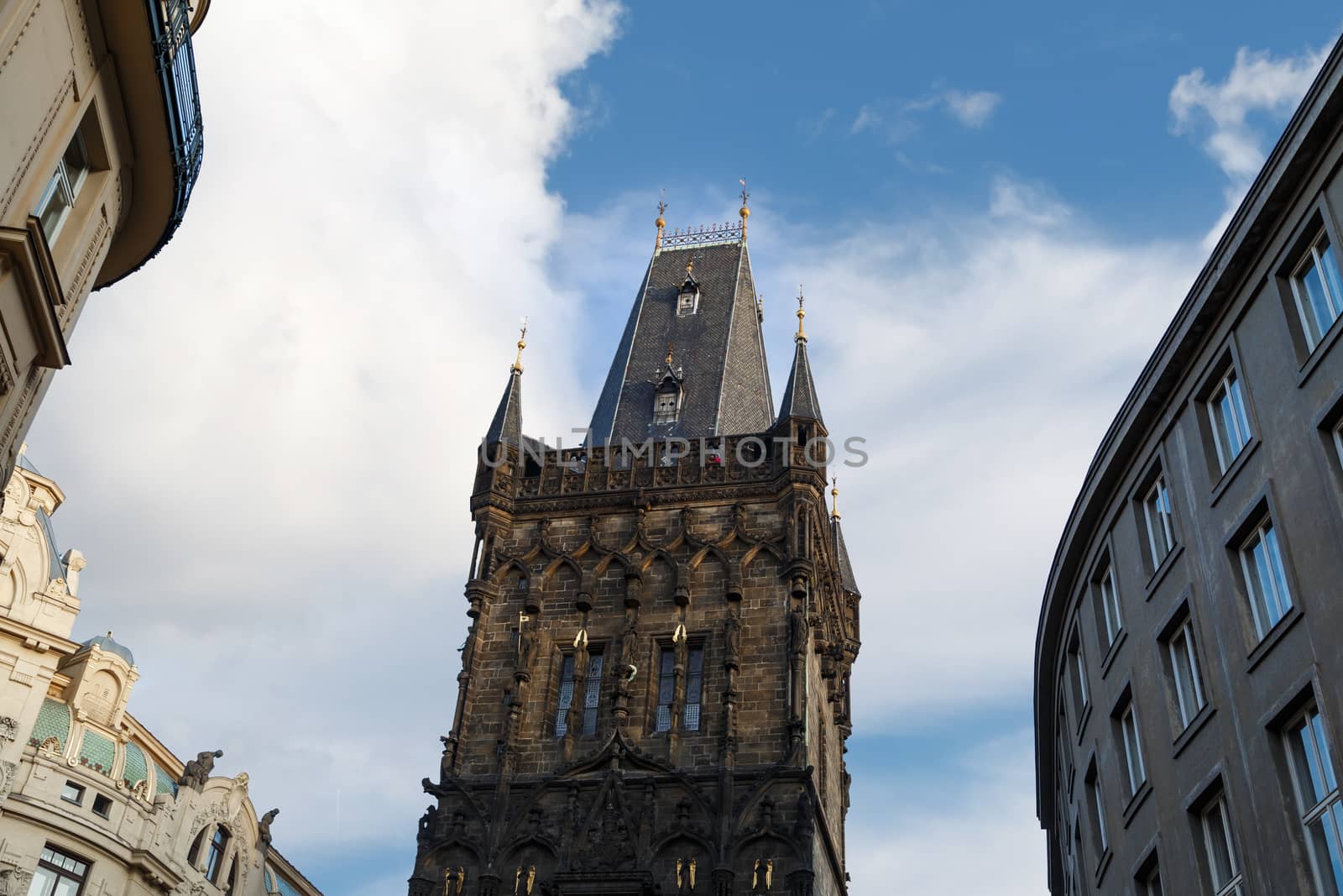 View of historical gothic Powder Tower also known as Powder Gate in old town of Prague, on cludy blue sky background.