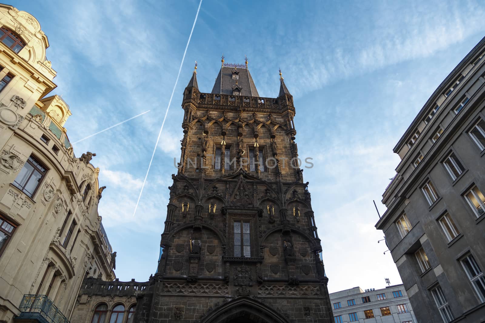 View of historical gothic Powder Tower also known as Powder Gate in old town of Prague, on cludy blue sky background.