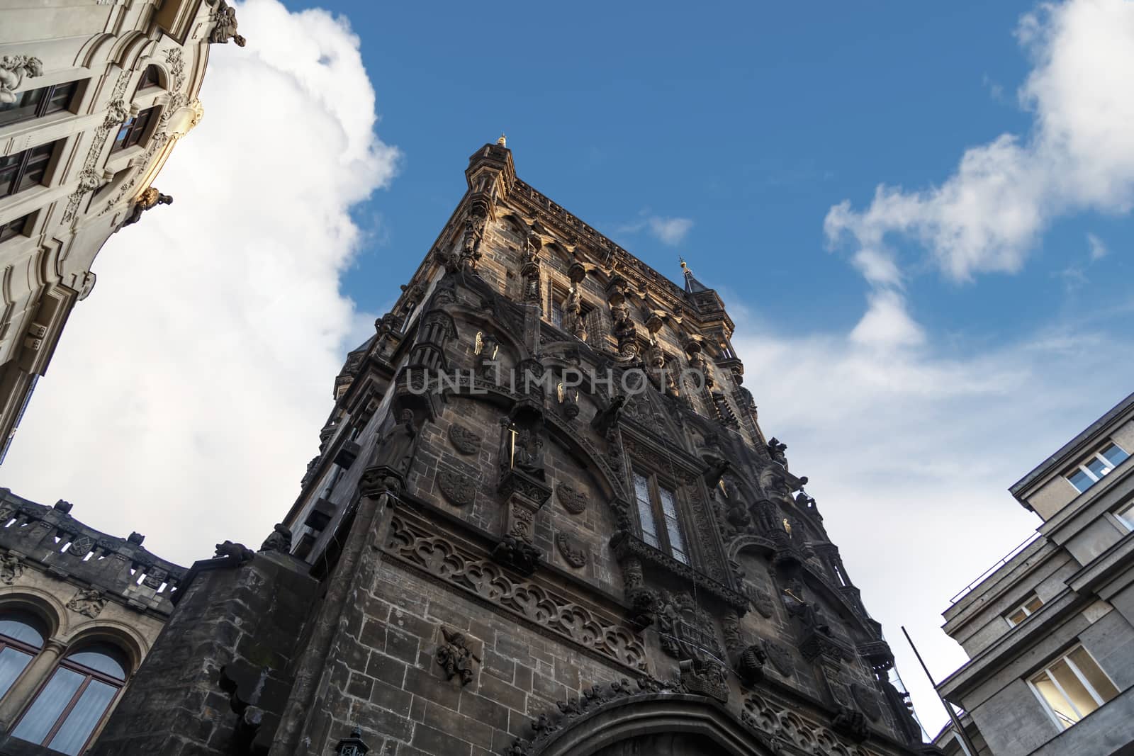 View of historical gothic Powder Tower also known as Powder Gate in old town of Prague, on cludy blue sky background.