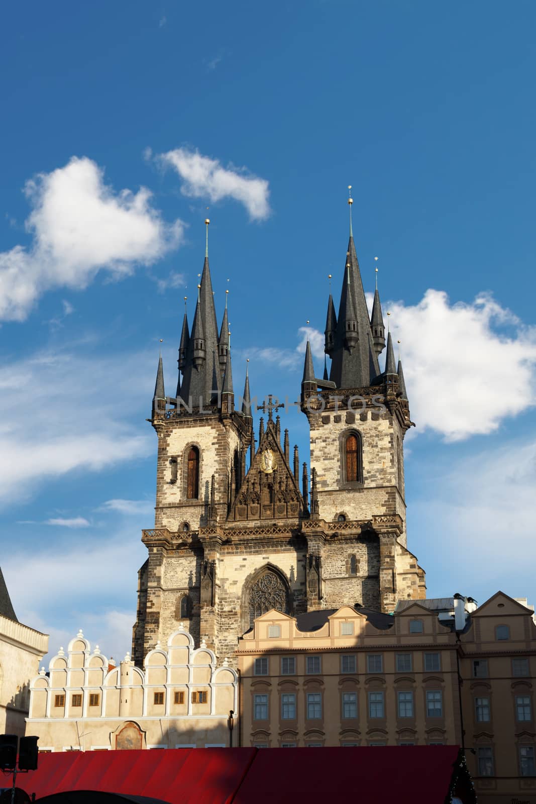View of historical gothic Church of Our Lady Before Tyn with the name of Tyn Church in Prague Old Town, on bright blue sky background.