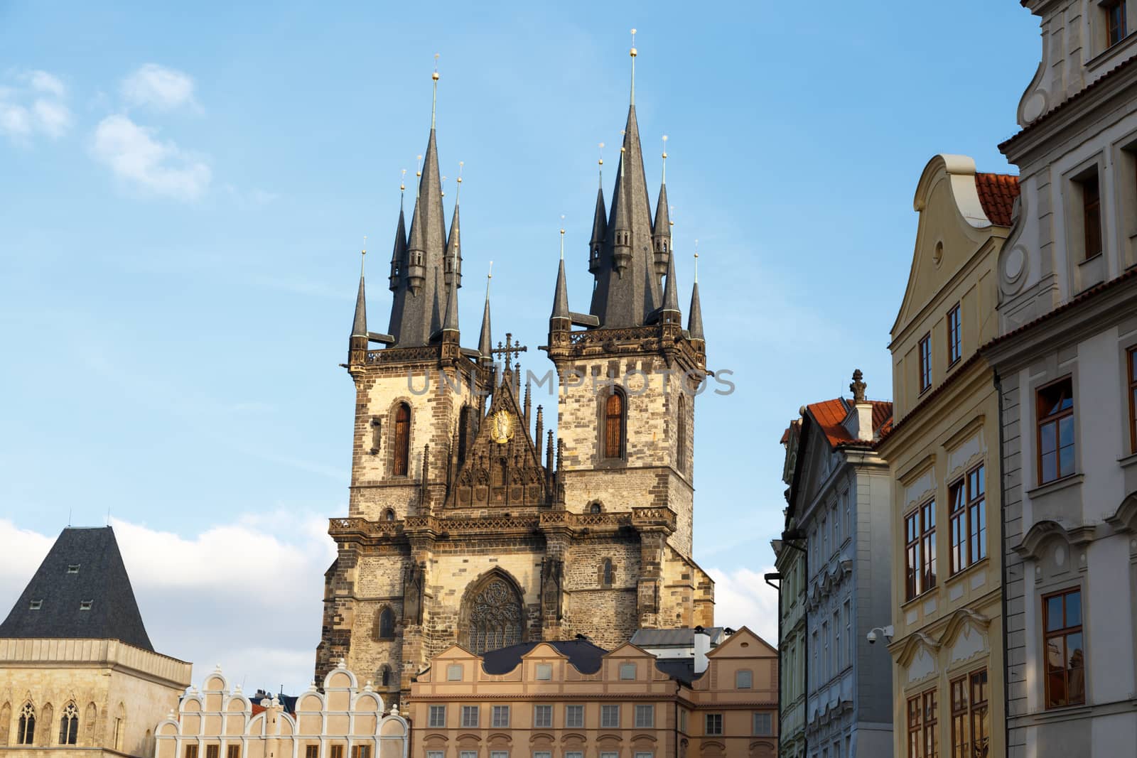 View of historical gothic Church of Our Lady Before Tyn with the name of Tyn Church in Prague Old Town, on bright blue sky background.