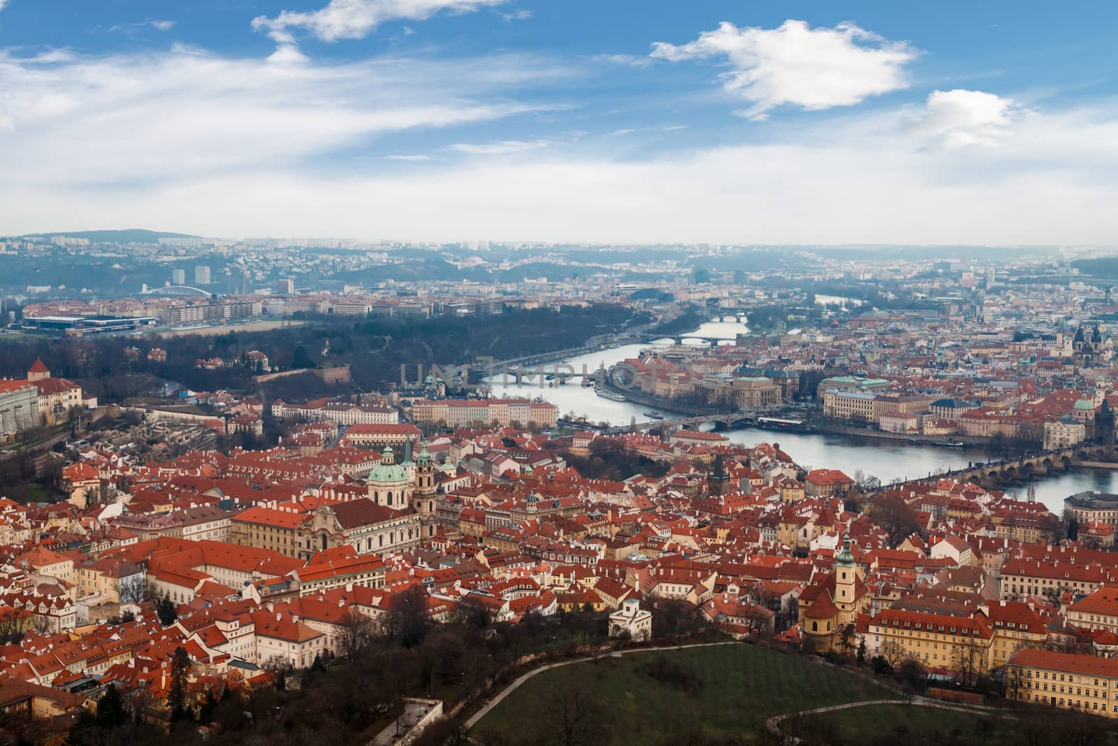 General top view of historical gothic Prague cityscape with old buildings and towers around, on cloudy sky background.