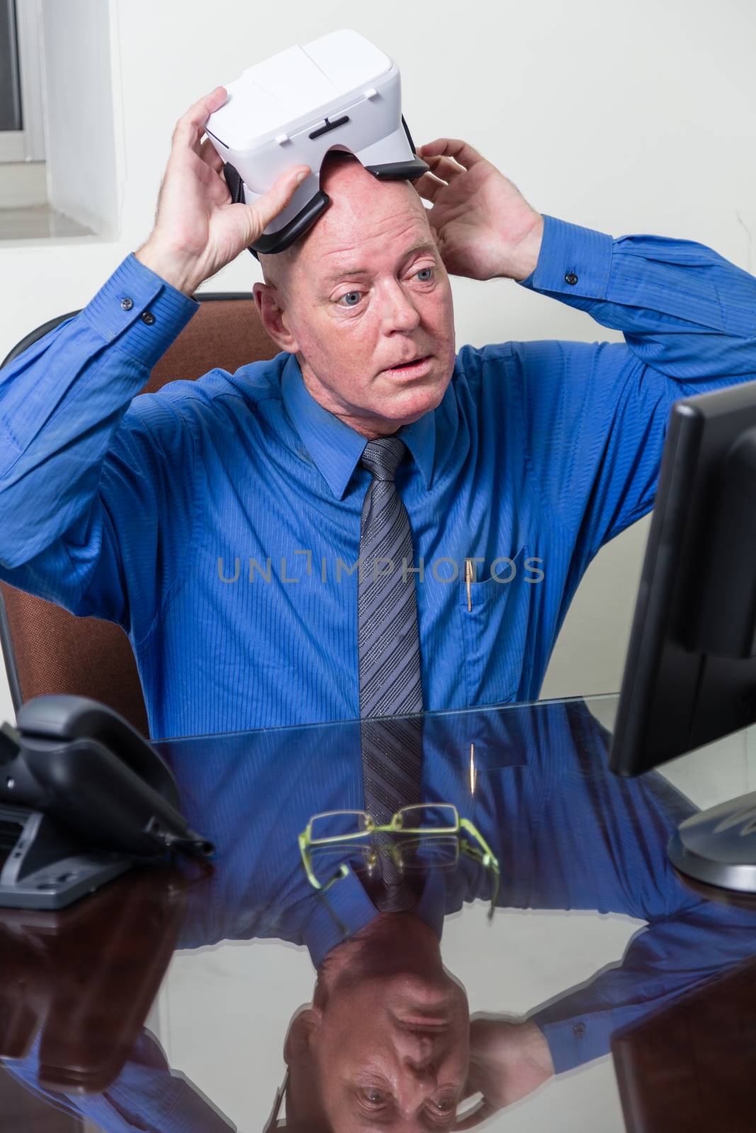 Corporate executive putting on virtual reality headset