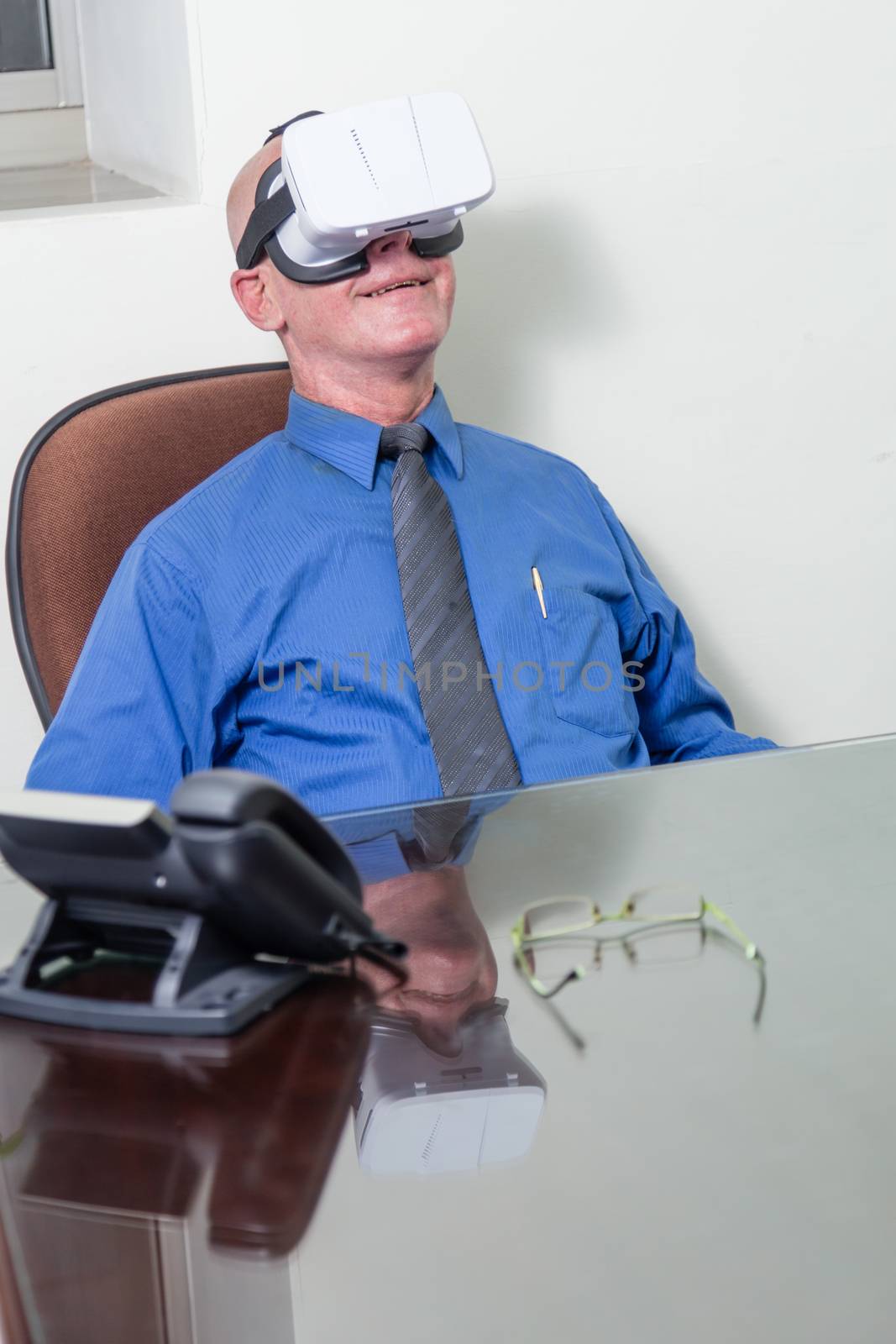 Smiling corporate executive wearing virtual reality headset