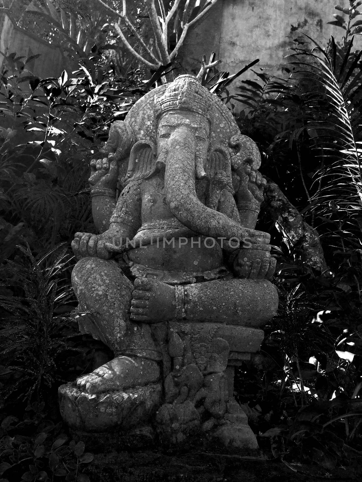 This is a statue of the hindu god Ganesh. He is the Lord of Good Fortune who provides prosperity, fortune and success.  He is the Lord of Beginnings and the Remover of Obstacles of both material and spiritual kinds.
He was beheaded by Shiva for not being aloud to pass through the door leading to Parvati's bathroom, later his creator Parvati attached a new head on the body, which was a elephants head.

because he was known as Parvati's doorkeeper, which is why he's often faced to doorways, to keep out the unworthy.