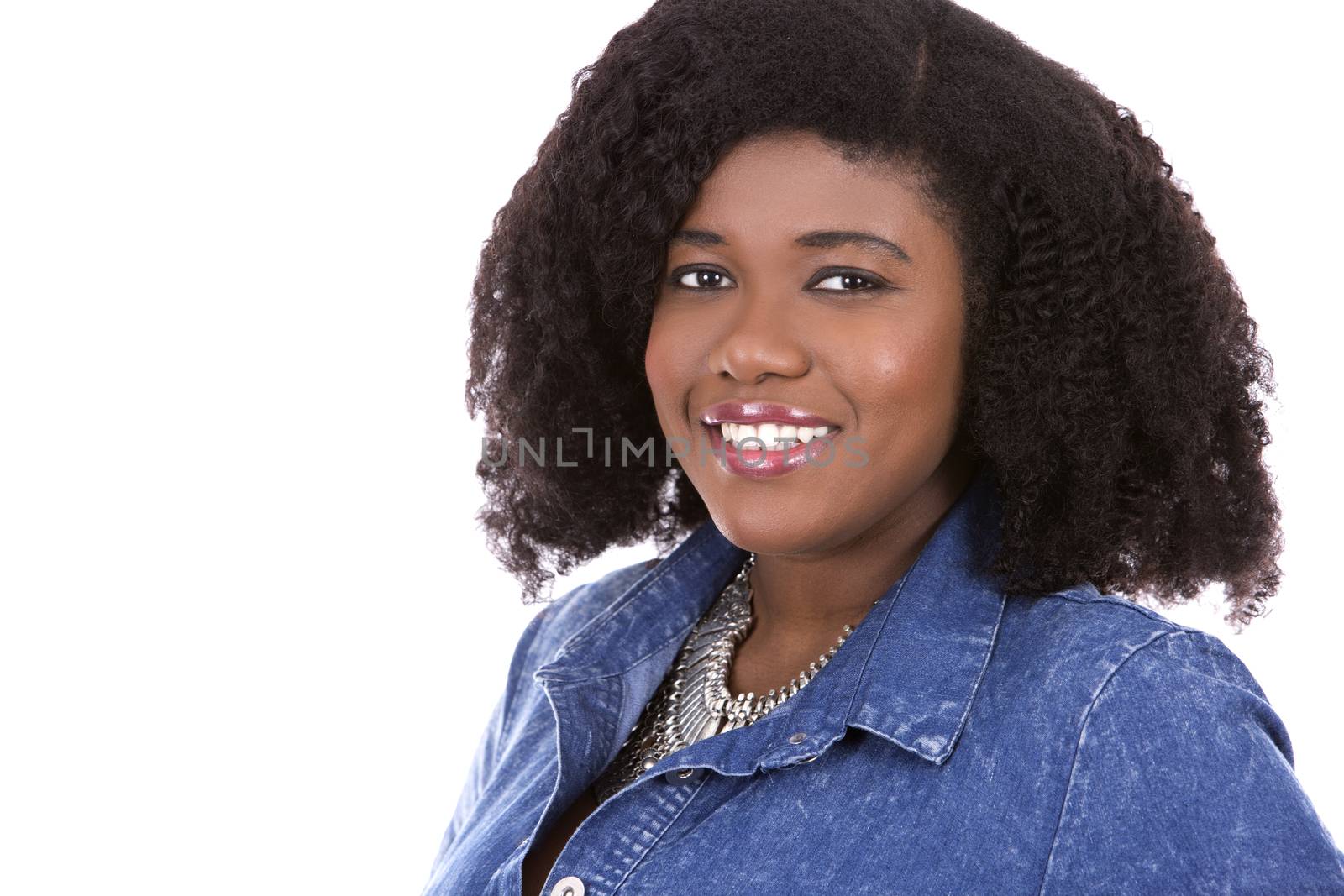 beautiful young black woman is wearing jean dress on white background