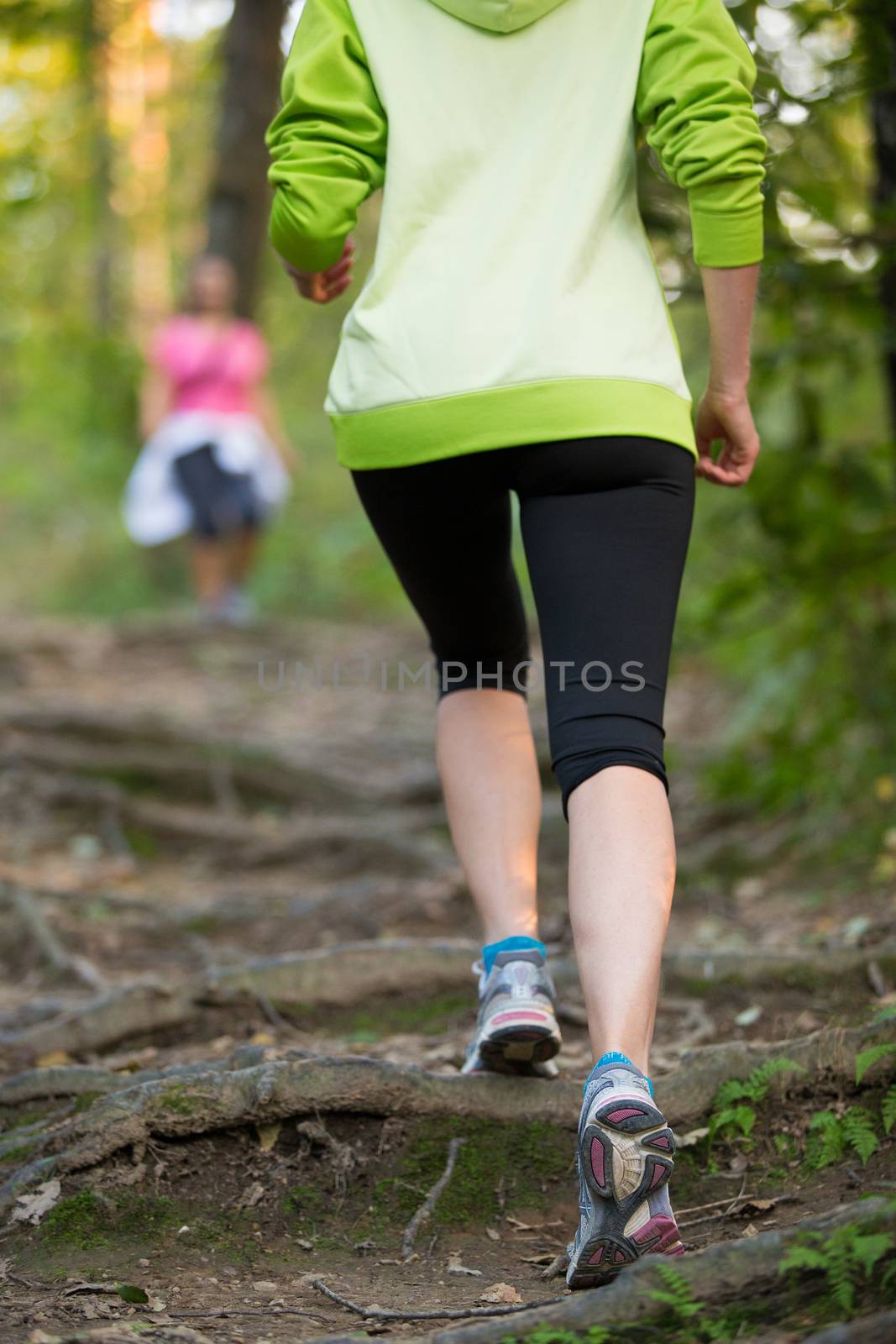 Female jogger outdoor workout in nature. Weight loss. Healthy lifestyle consept. Rear view. 