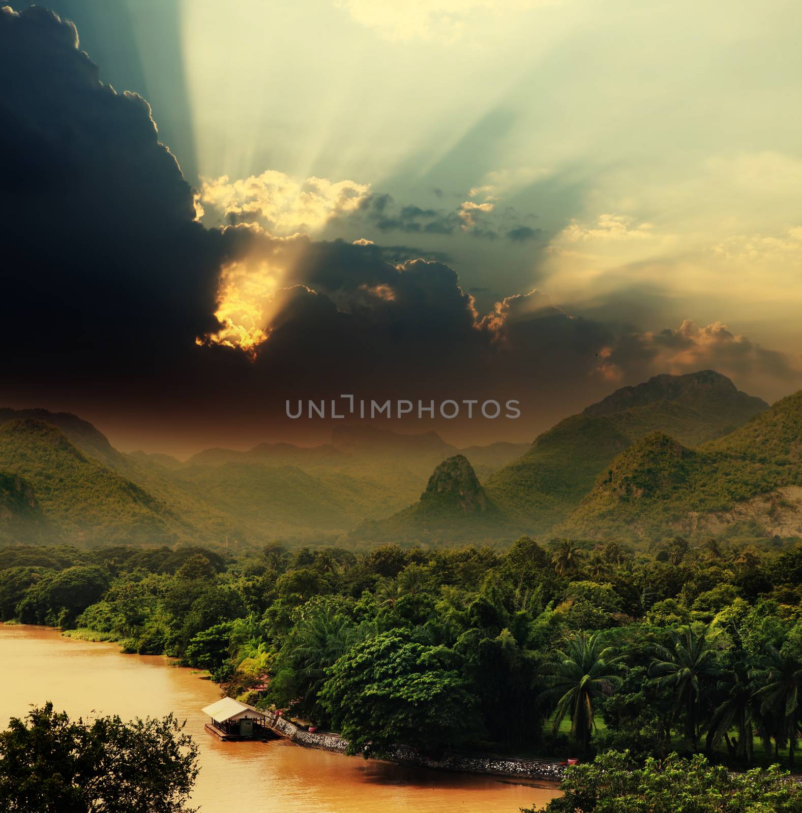 Sunset with rays over river by ssuaphoto