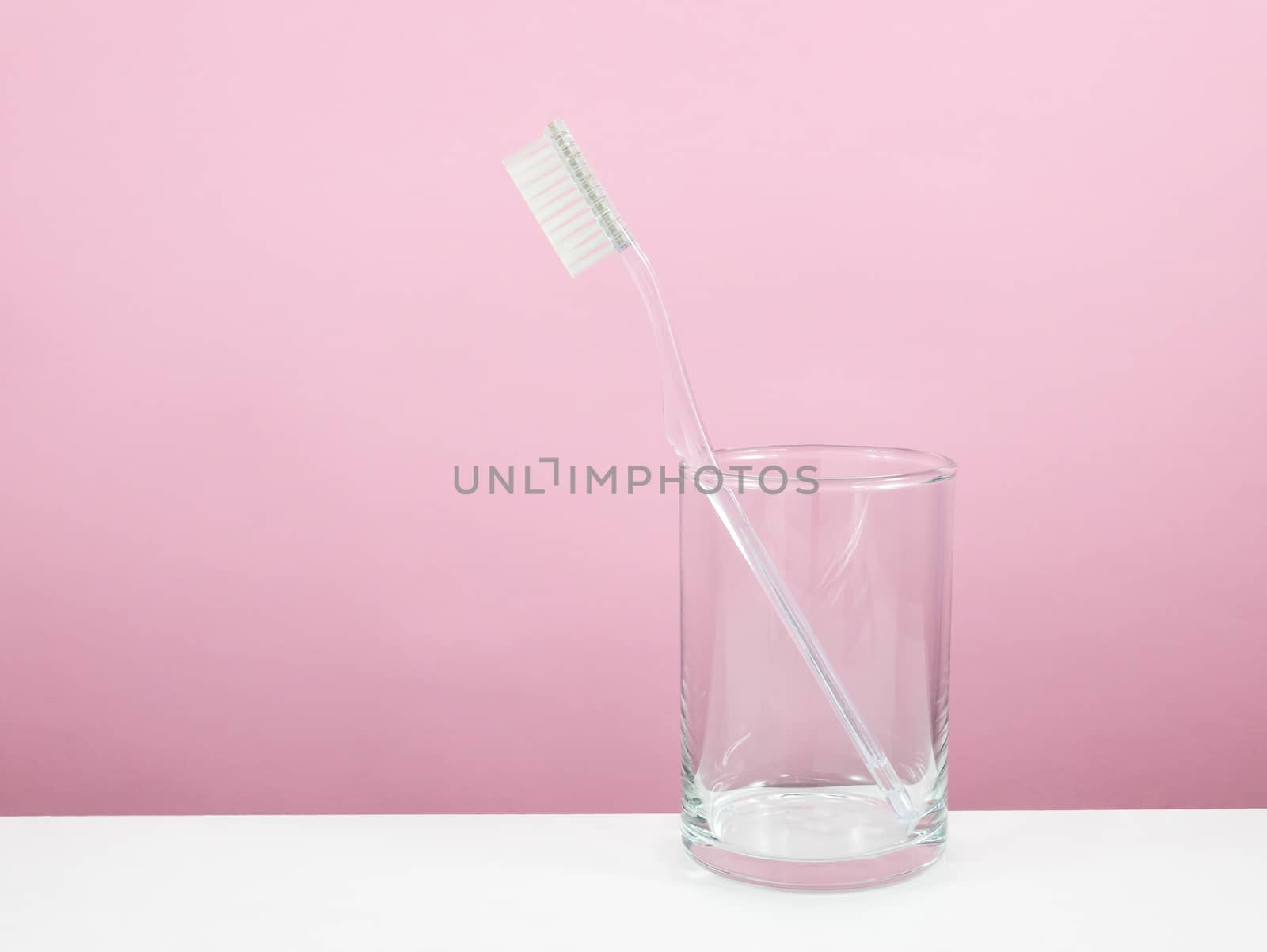 The clear toothbrush with small glass for brushing the teeth.