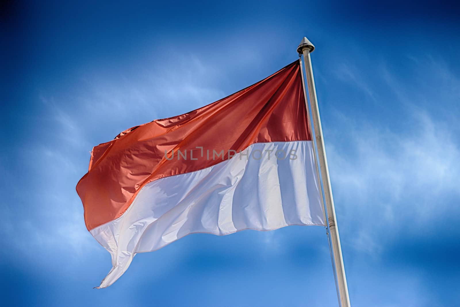 Monaco Waving Flag Against Blue Sky 