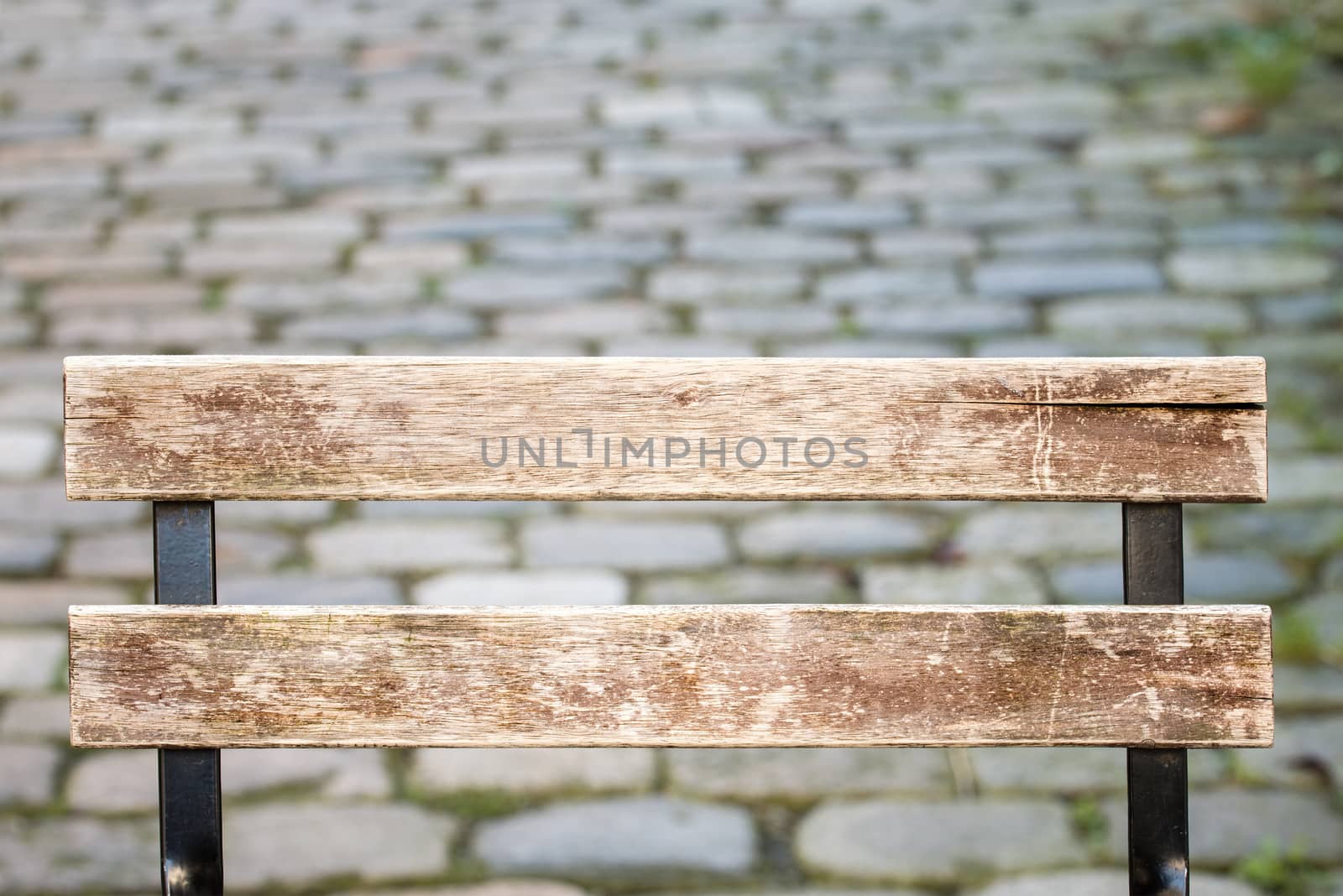 grunge wooden back of a chair, stoned path background