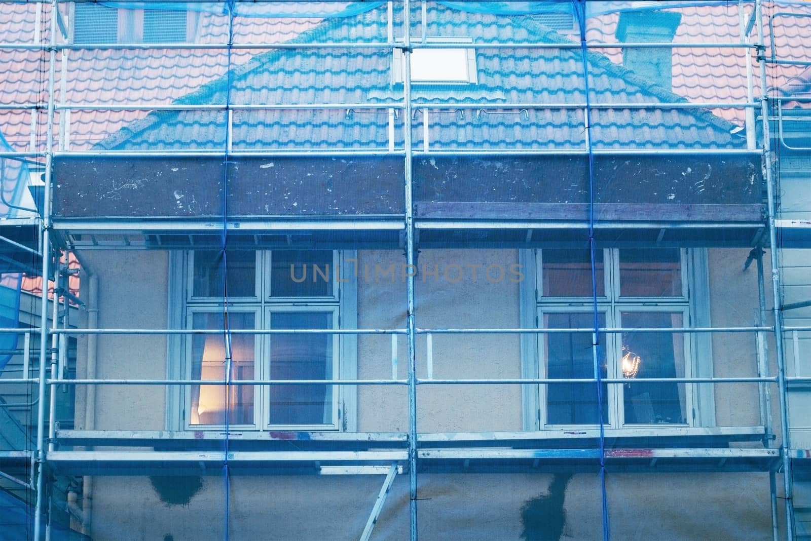 restoration facade of old house under blue net