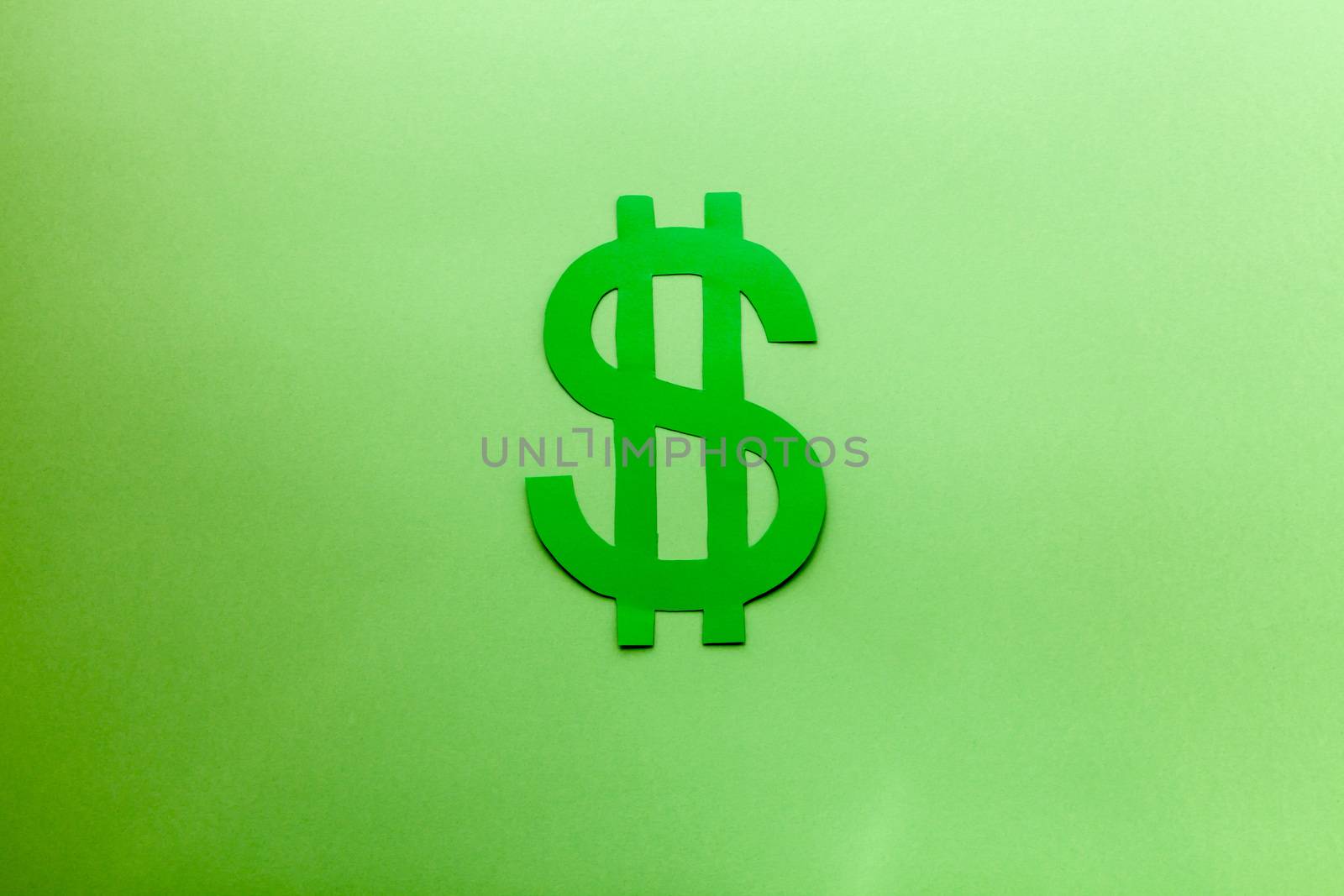 Green dollar symbol on a green background with a soft light