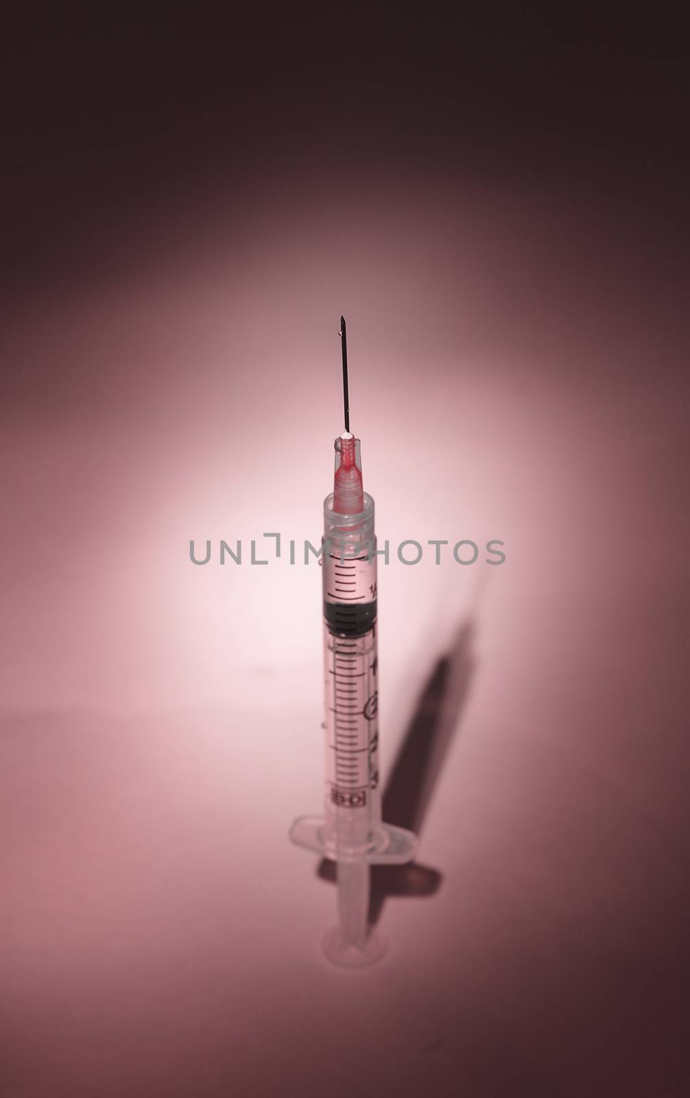 Long hypodermic needle ready for injection in a medical doctor’s office in the emergency room of a hospital.