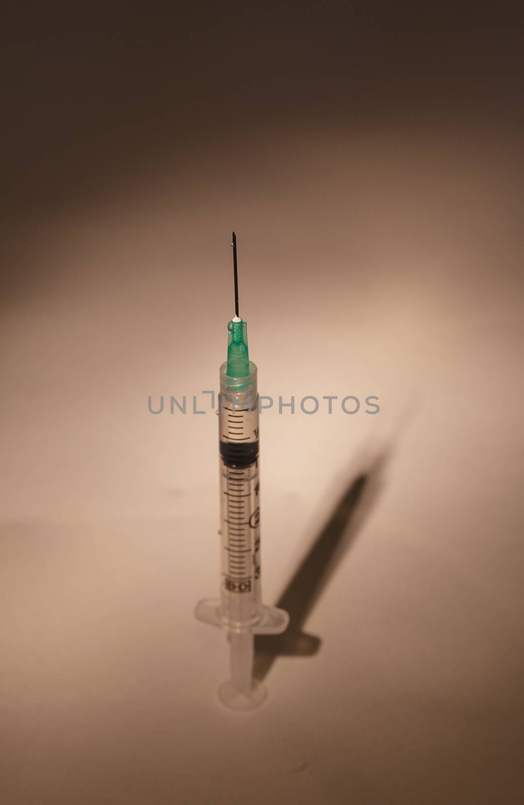 Long hypodermic needle ready for injection in a medical doctor’s office in the emergency room of a hospital.