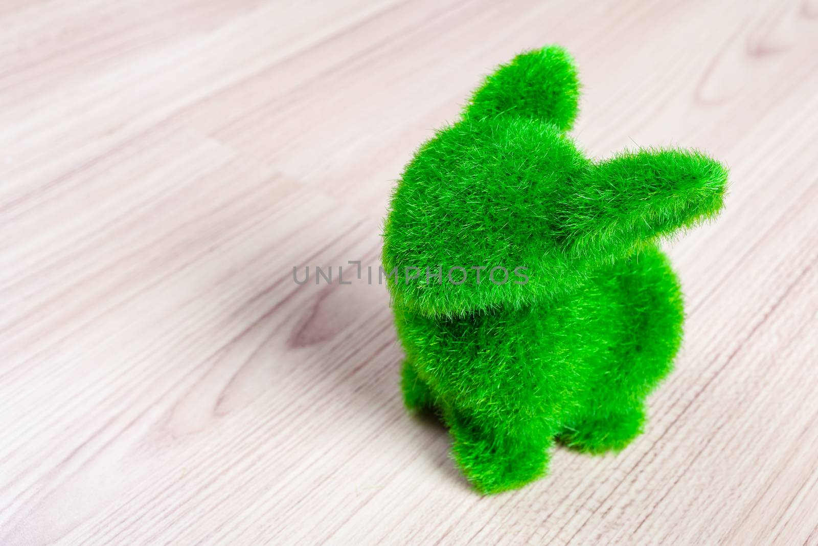 Little green rabbit on wooden floor, made from artificial grass by FrameAngel
