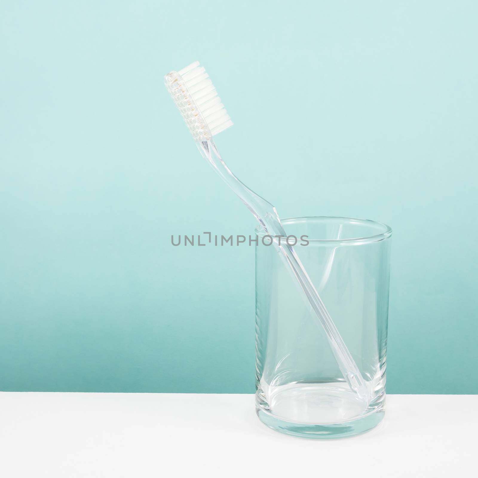 The clear toothbrush with small glass for brushing the teeth.