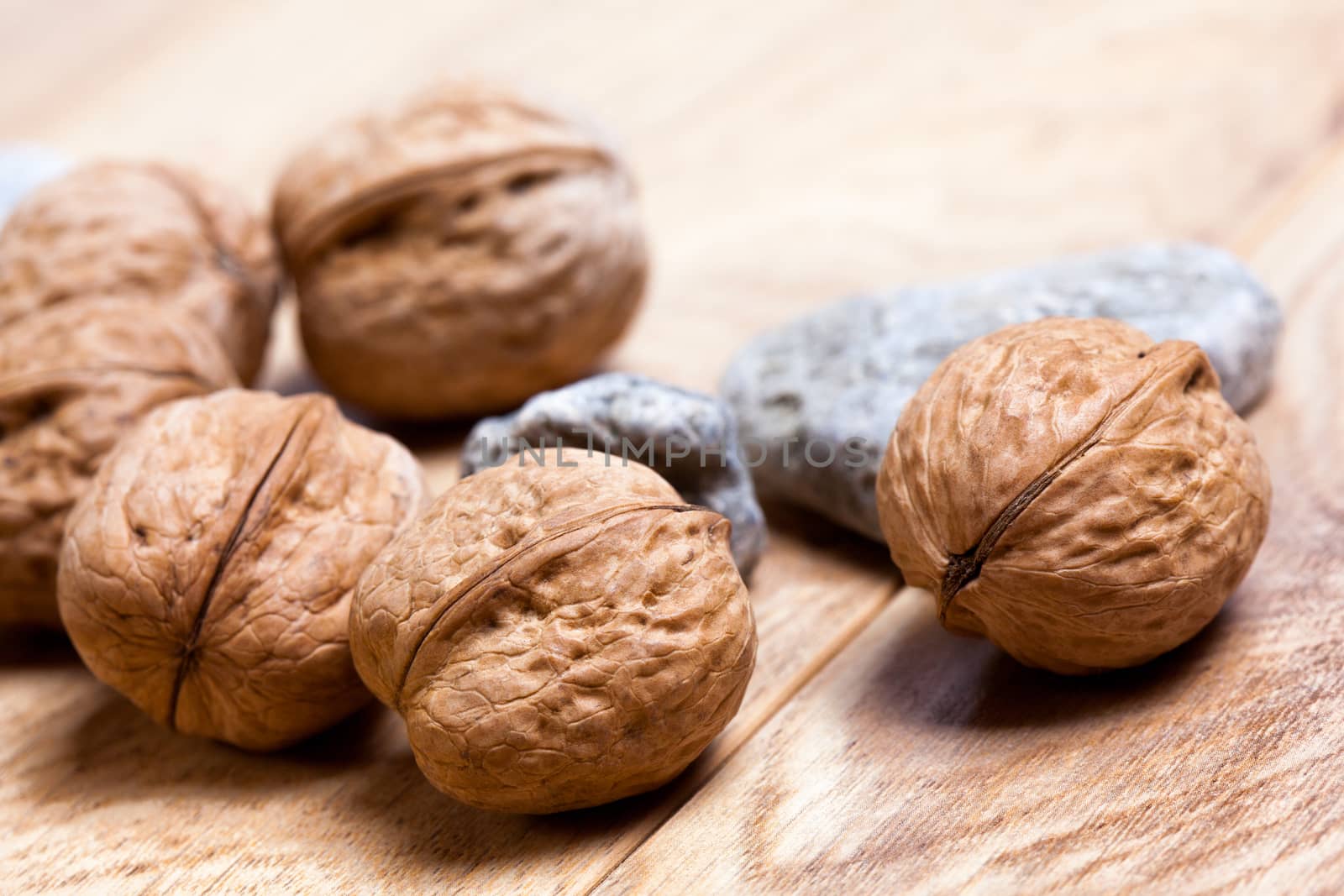 Walnuts on rustic wooden board closeup  light background