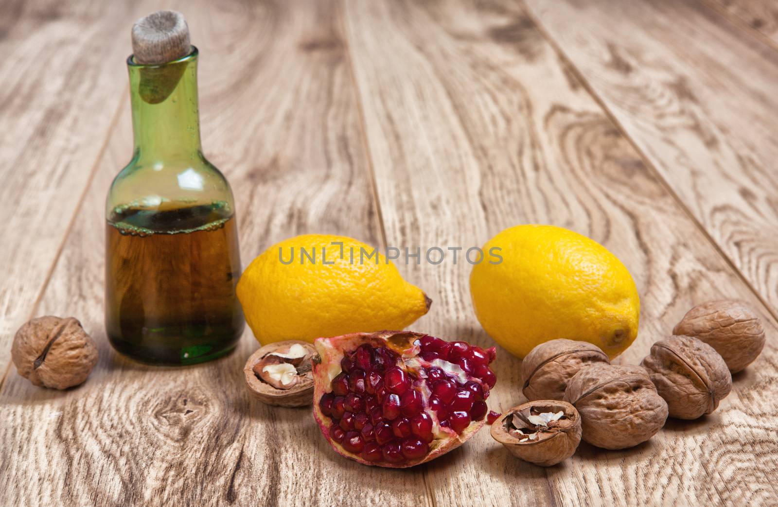 walnuts pomegranate and lemons on wooden table