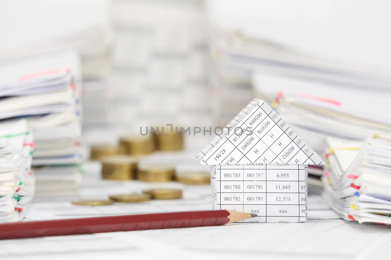 House and pencil with blur coins between overload of paperwork by eaglesky