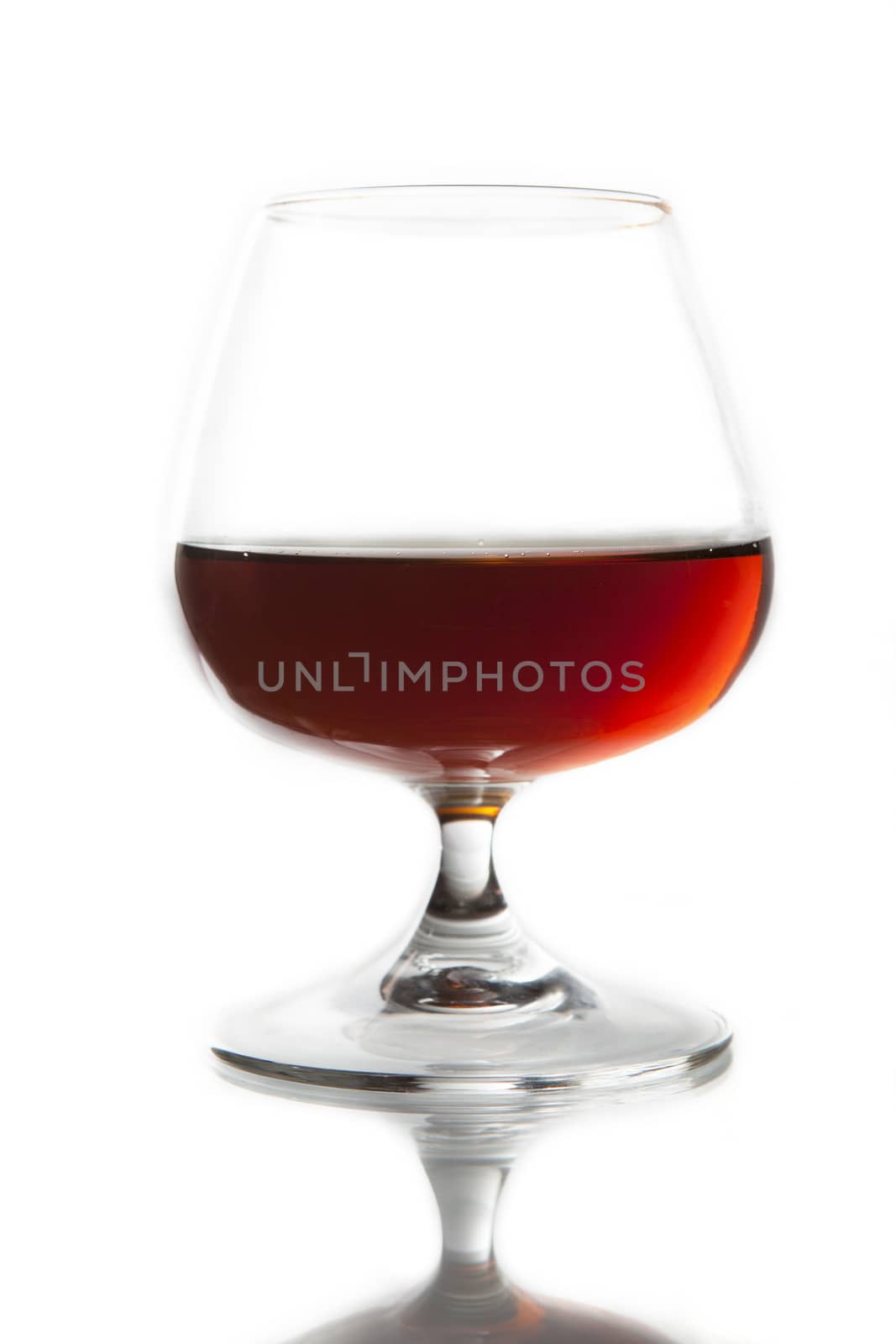 A glass with a drink of red color on a white background